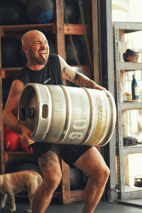 A Swenson Boxing member lifting a keg during conditioning