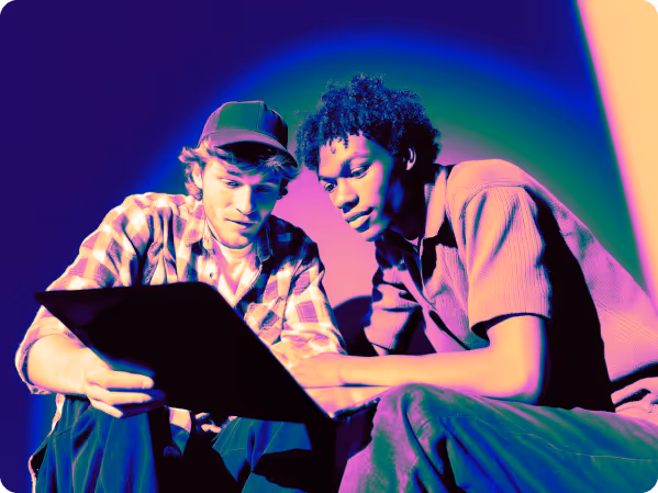 two men looking at laptop crypto community