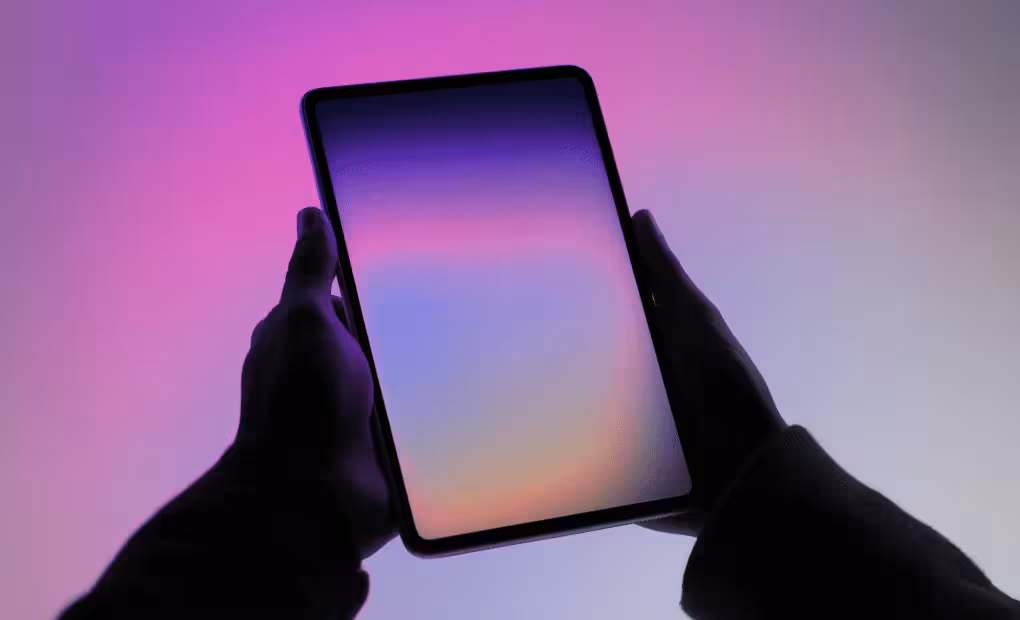 Hands holding tablet with gradient screen representing Polkadot blockchain projects and Web3 innovation