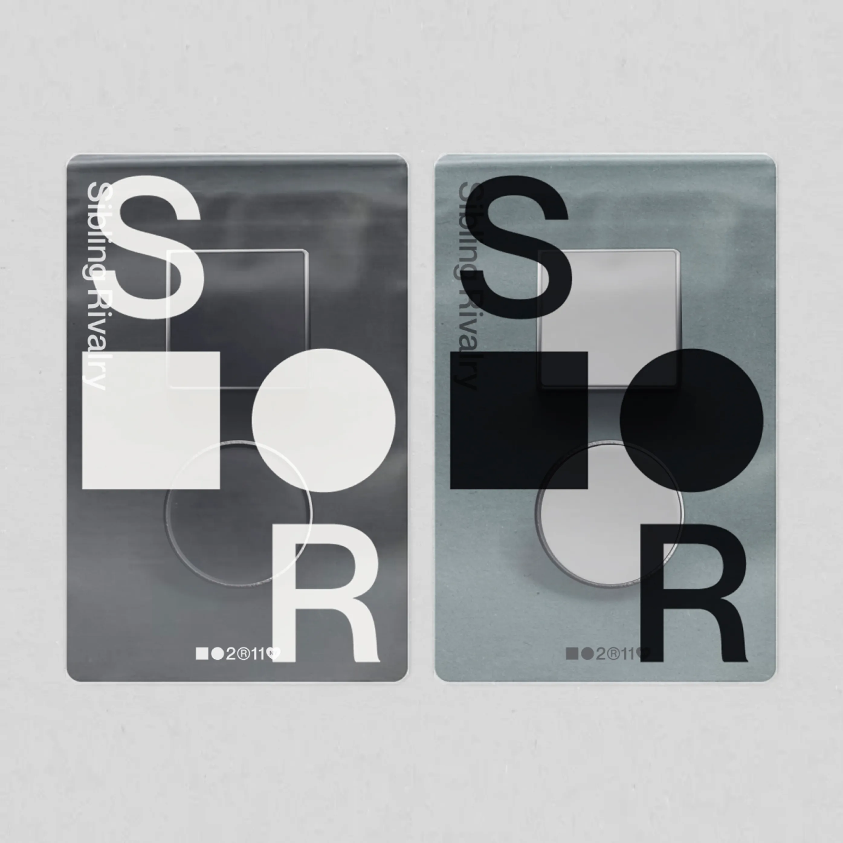 Two Sibling Rivalry cards with S and R letterforms and geometric shapes