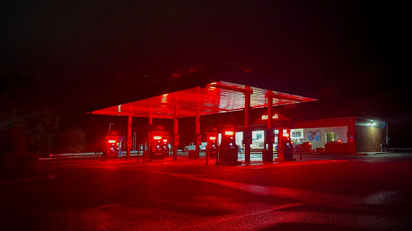 Gas station glowing red at night