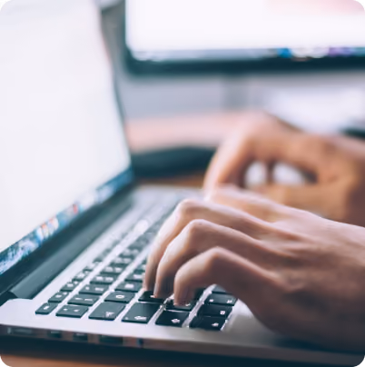 hands typing on a keyboard of a laptop