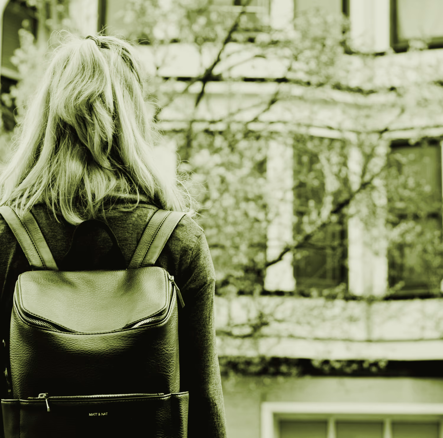 student standing in a quad with a backpack on