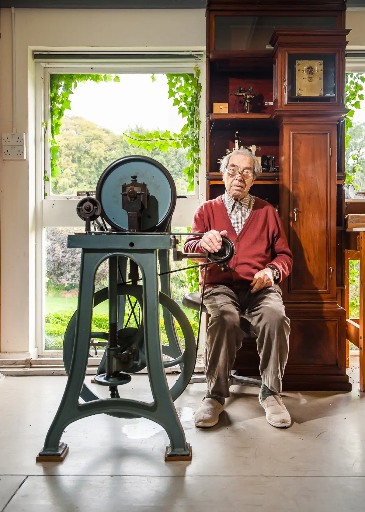 George Daniels seated beside workshop machinery in August 2011