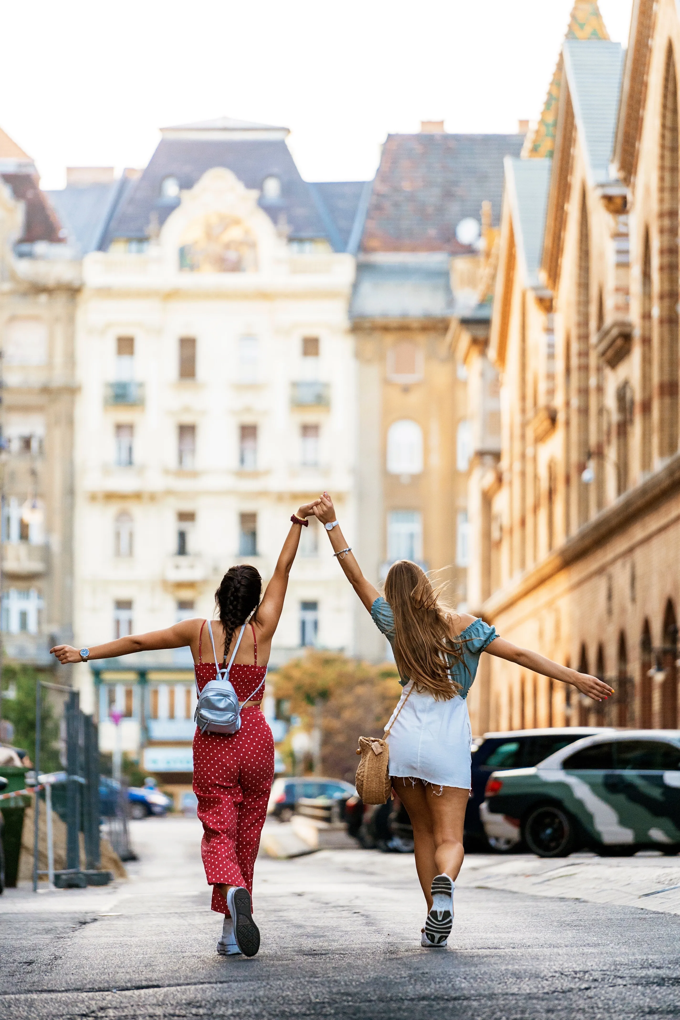 Girls walking in the city holding hands