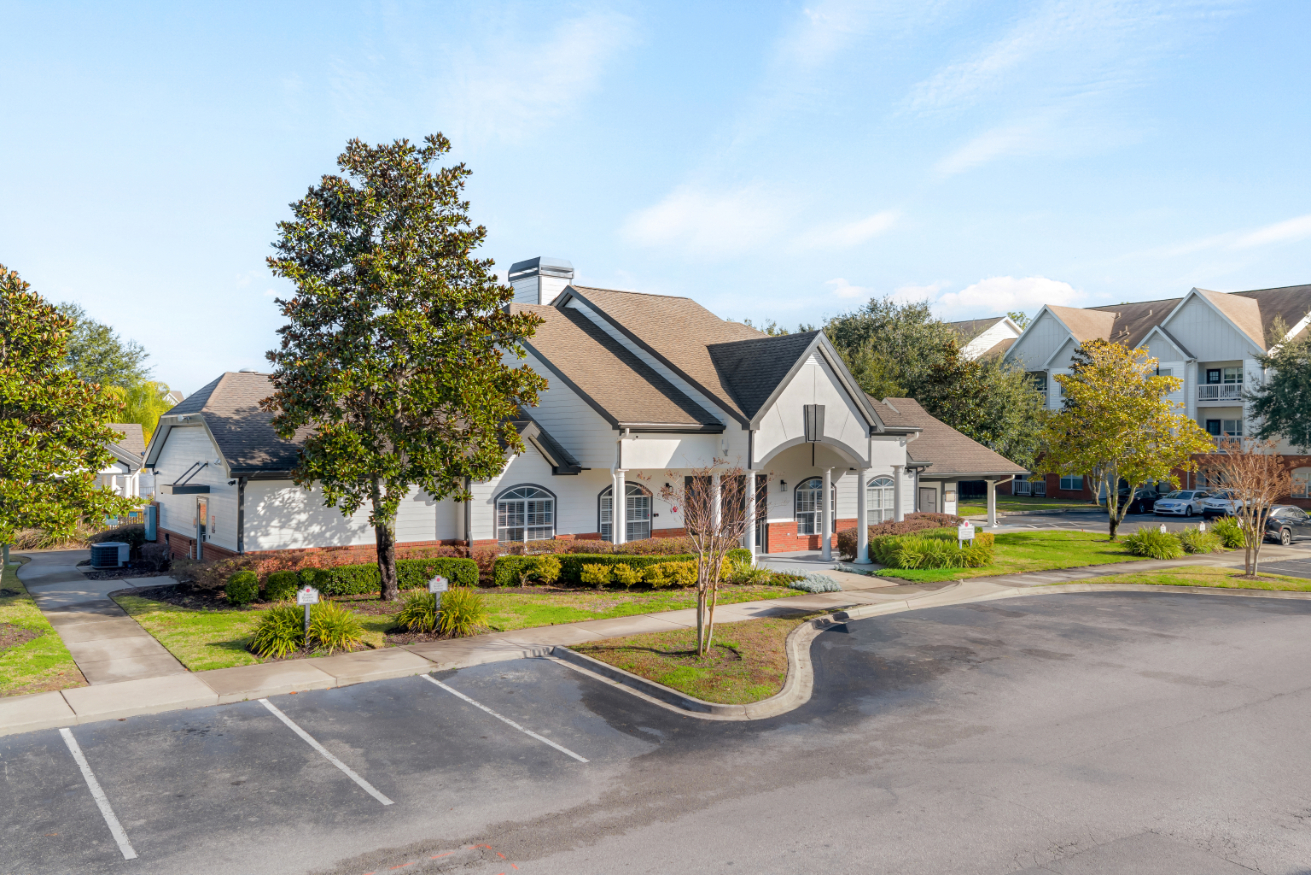 Exterior of the community clubhouse and pool house, located next to the parking lot at The Finley in Jacksonville, FL.