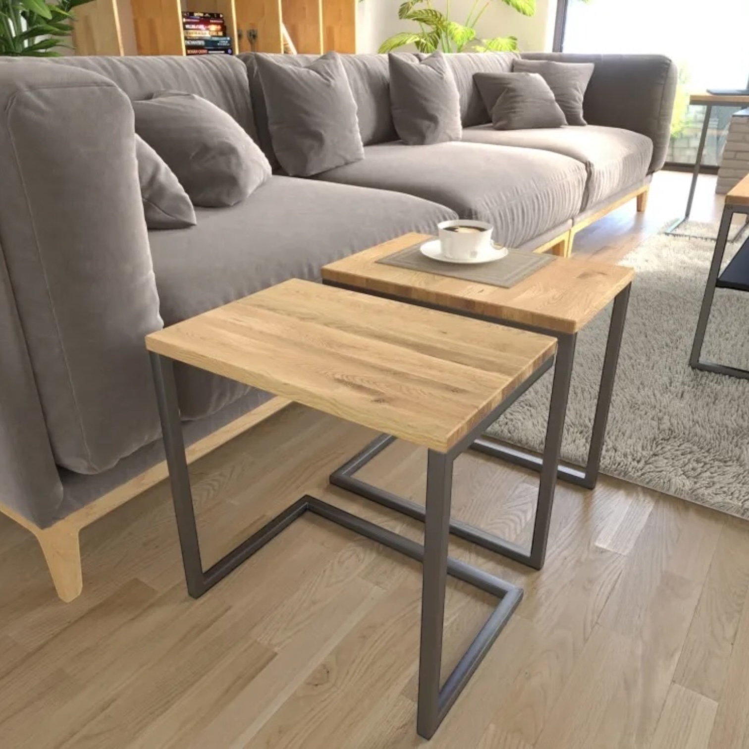 Detailed view of Tibo table highlighting the oak wood grain and durable metal legs in a loft-style setting
