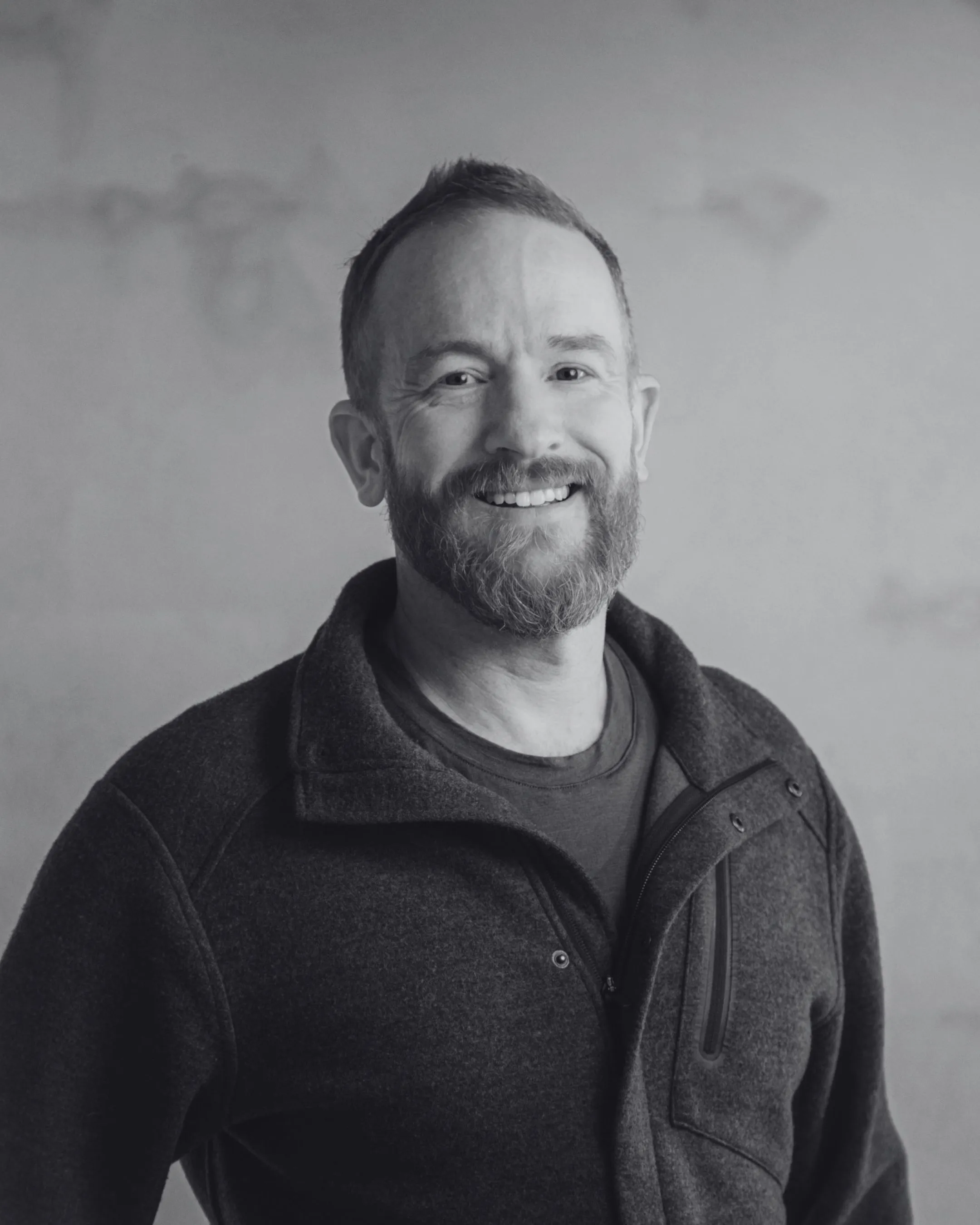 A professional headshot of Daniel Alexander