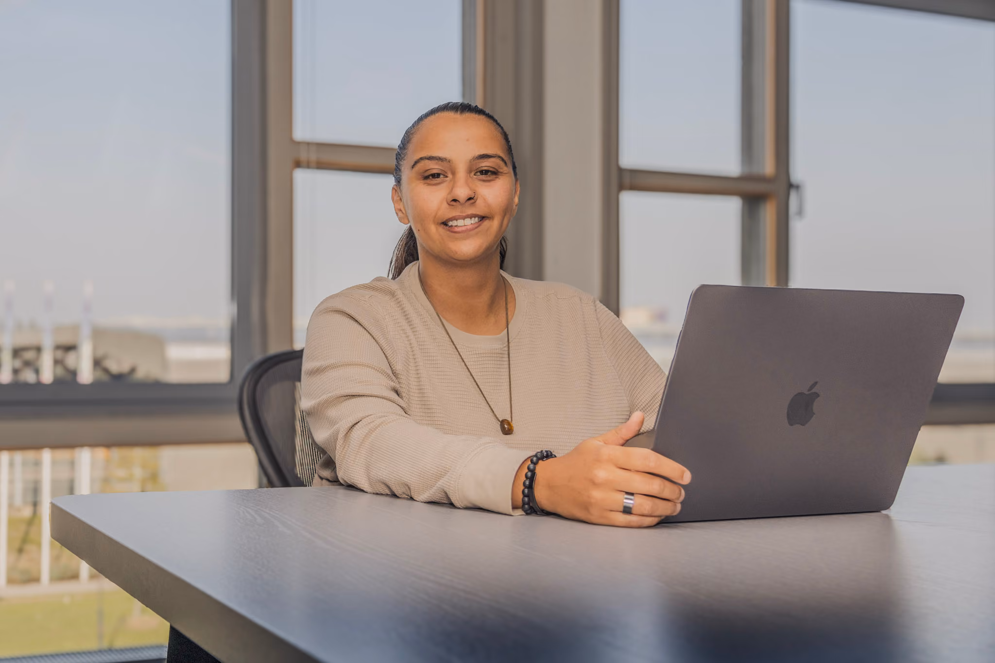 Yasmeen behind a laptop