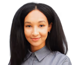 Portrait of a smiling woman with long black hair wearing a gray button-up shirt.