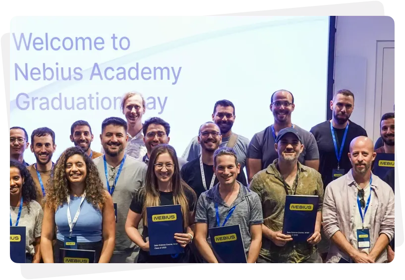 Group of graduates smiling and holding Nebius Academy diplomas during a graduation ceremony.