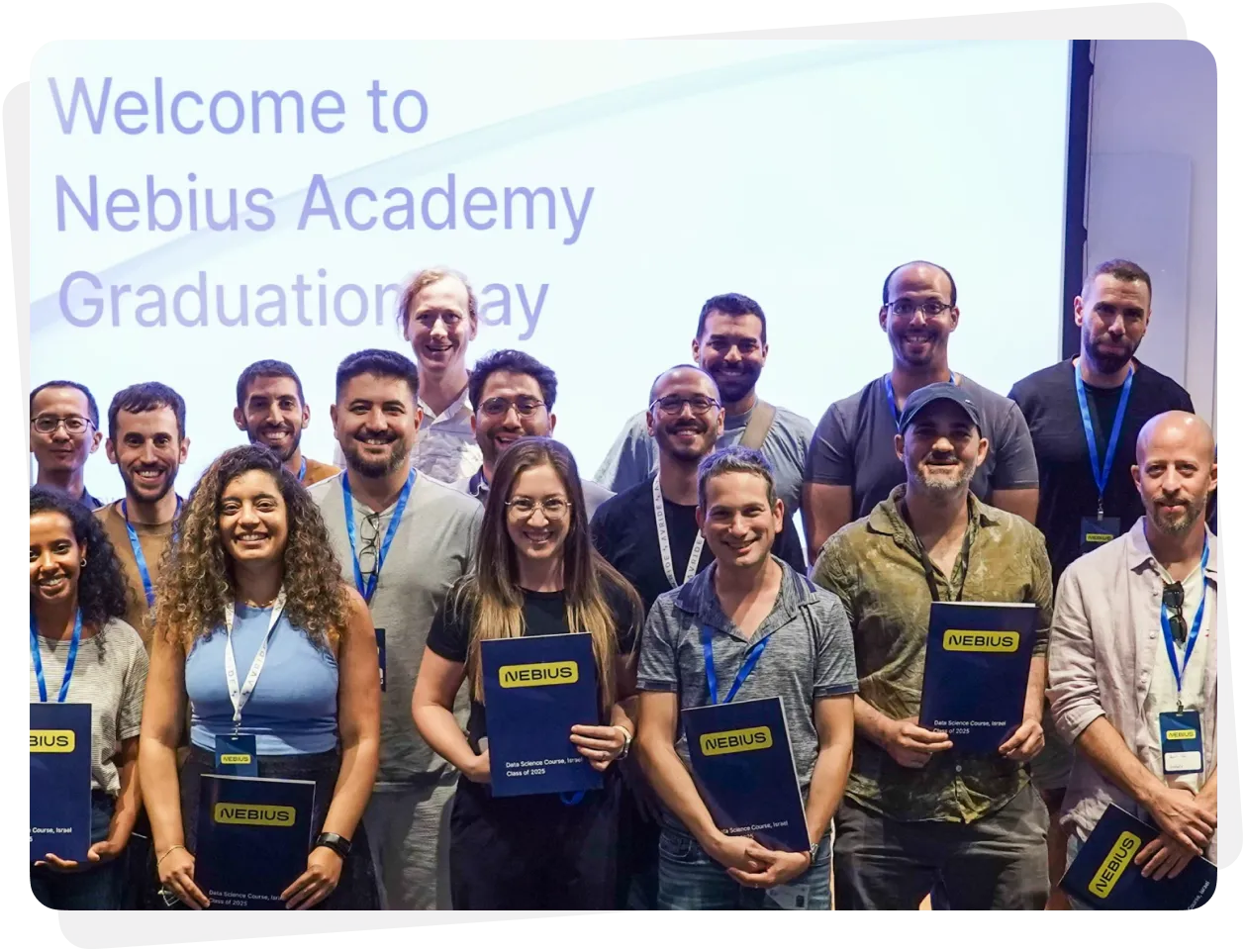 Group of graduates smiling and holding Nebius certificates at Nebius Academy Graduation Day.