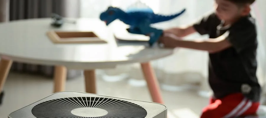 A child plays near an air purifier.