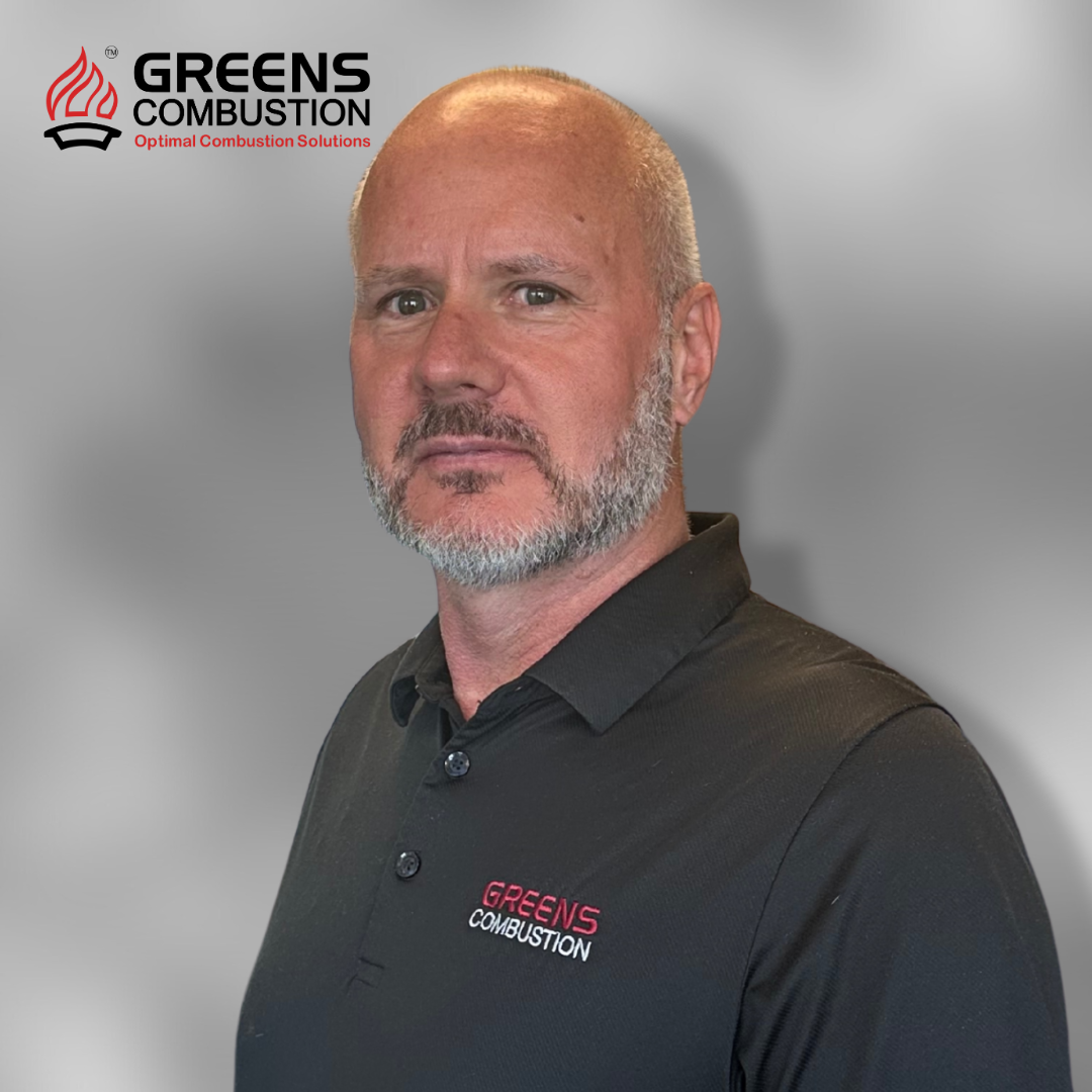 Richard Withnall, Managing Director of Greens Combustion, professional portrait with company logo backdrop.