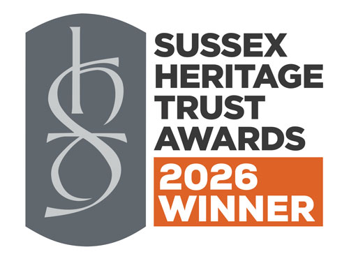 Sussex Heritage Trust Awards 2026 winner logo with stylized letters on gray and orange background.
