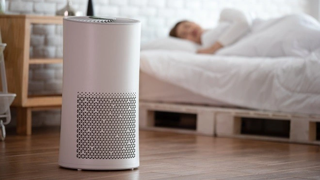 Air purifier running while person sleeps.