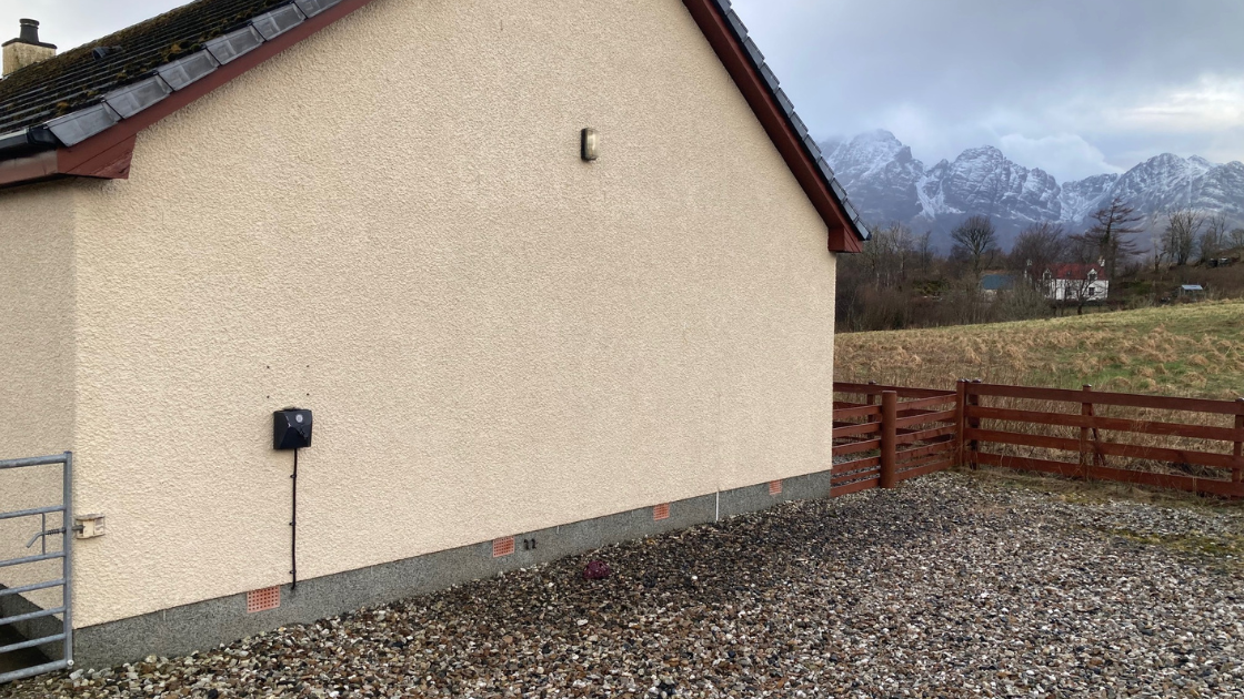 A voltshare EV chargers in a rural site in Scotland with mountains in the background