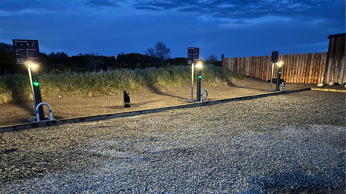 Three voltshare EV chargers with lights