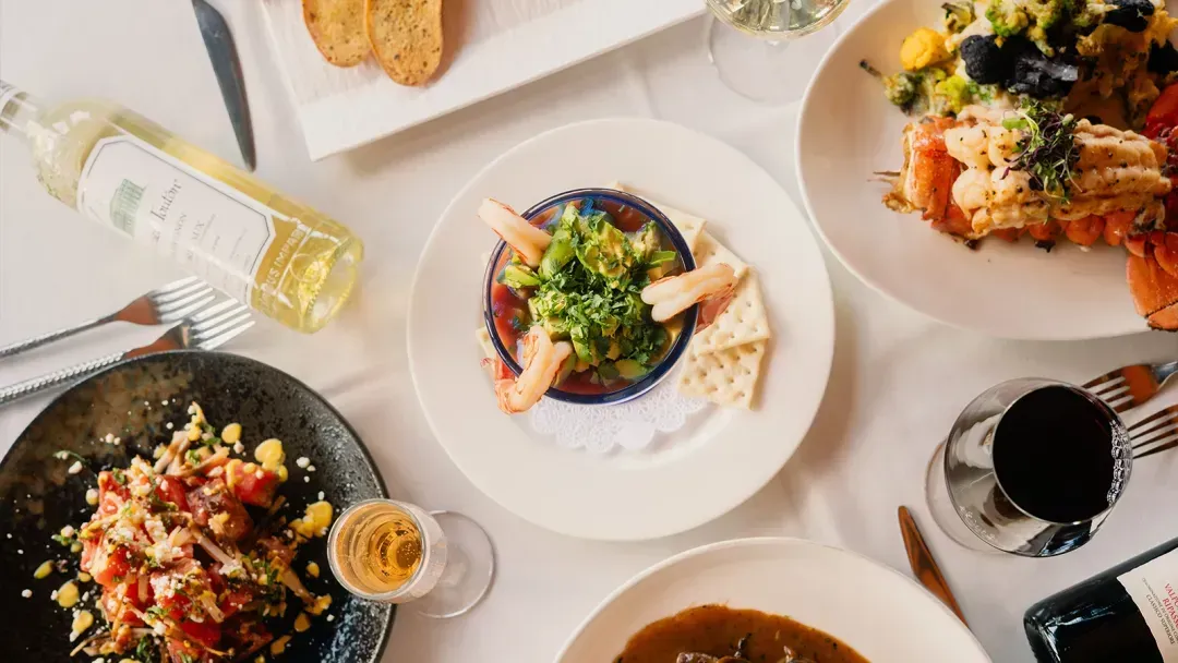 flatlay of seafood menu items on prime29's cityside al fresco patio dining