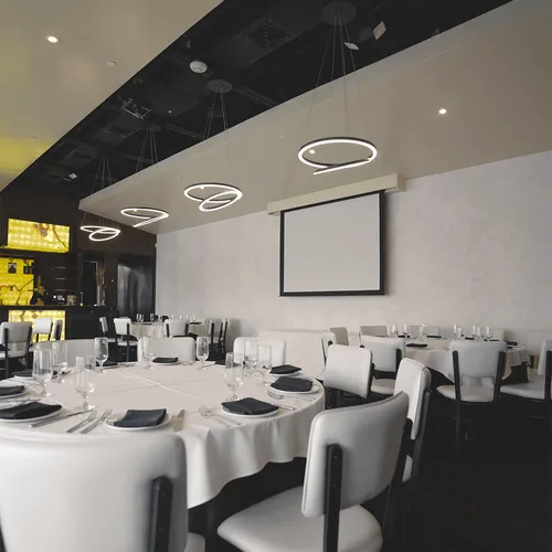 corporate event with round tables and a projector at prime29 steakhouse in our onyx room for private events