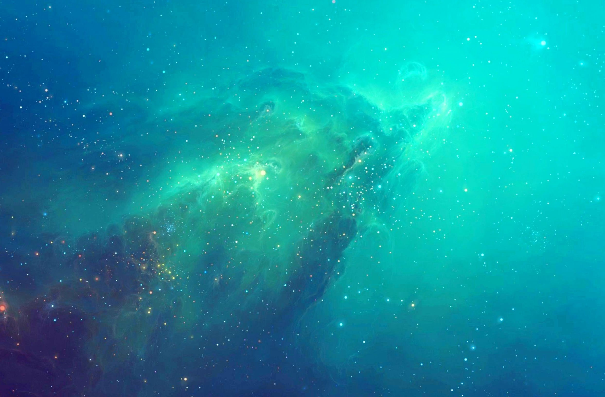 Nebulosa dai toni verde bluastro con numerose stelle sparse nello spazio.