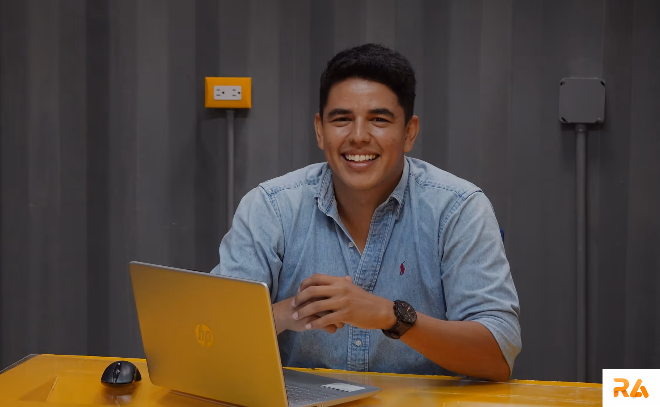 Patent lawyer working with his laptop and smiling on camera