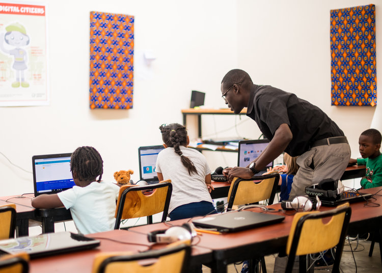 A teacher helping his students with a problem