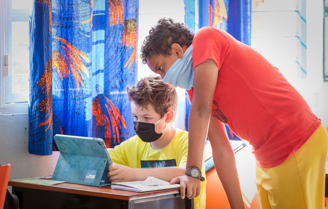 Two children looking for a solution for their homework