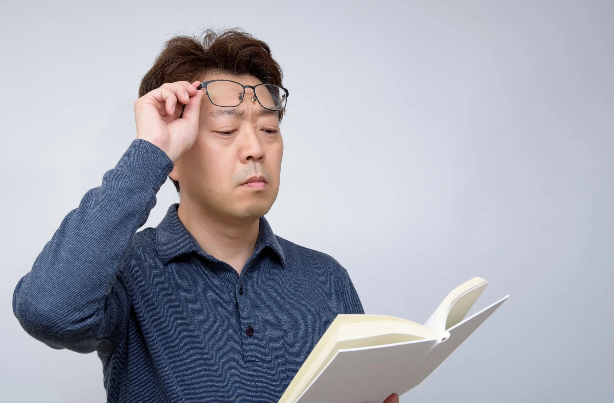 Woman at elevators in front of San Antonio Eye Specialists sign.