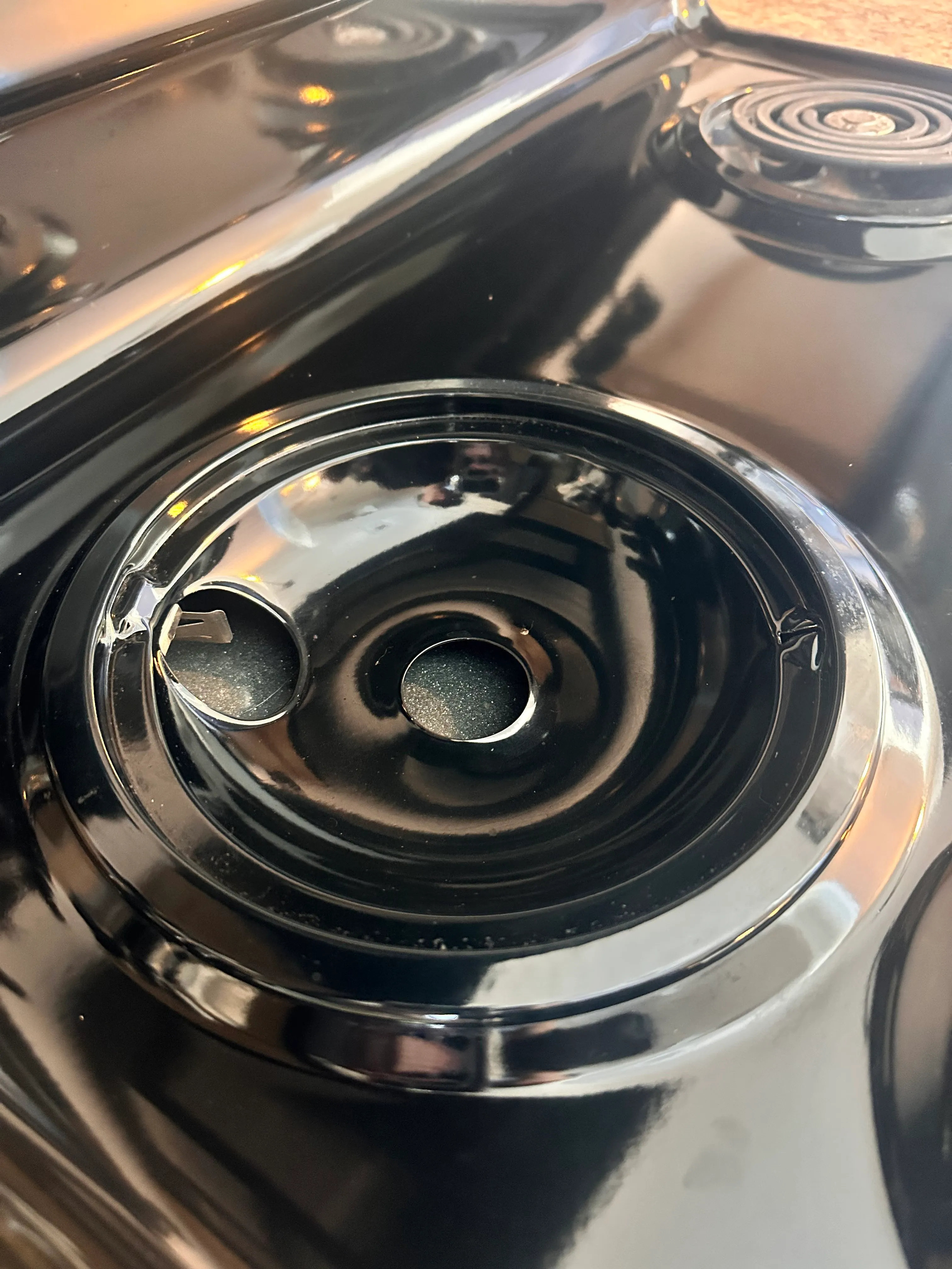 After picture of a stove drip pan which appears shiny and clean