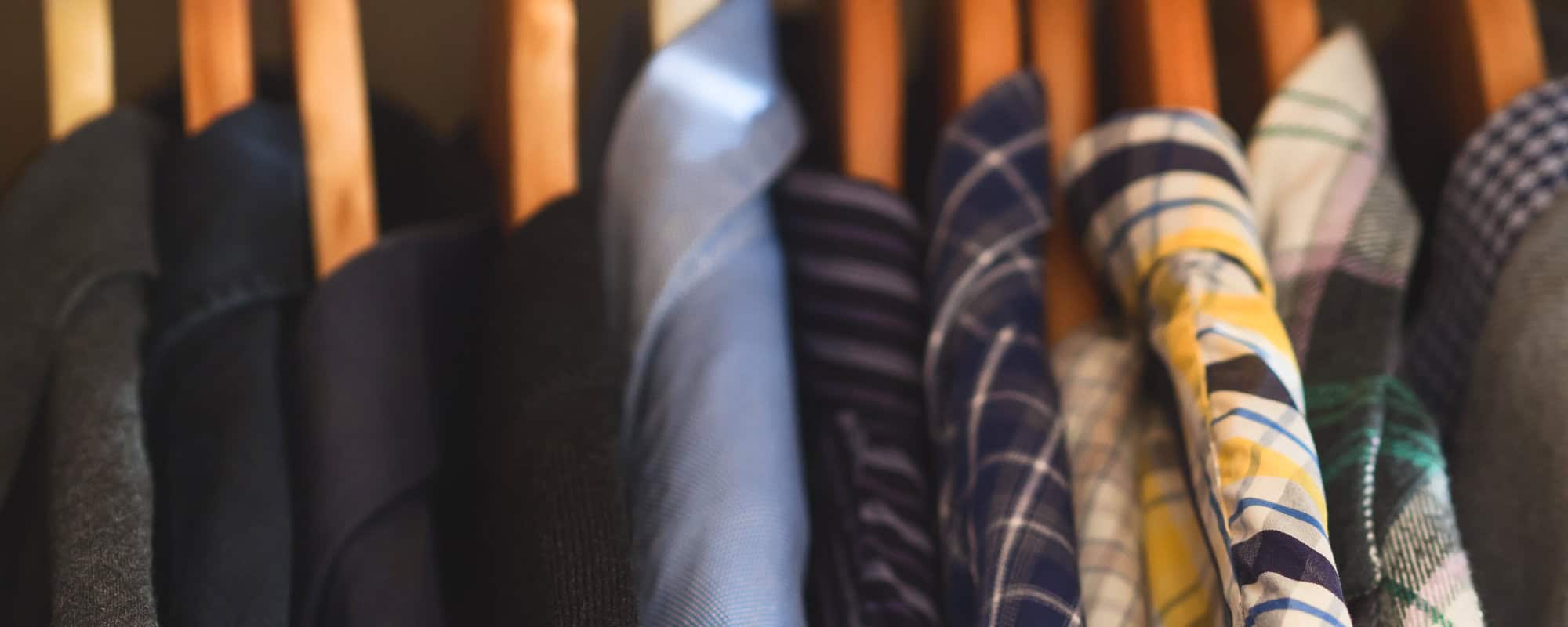close up of hangers of dress shirts