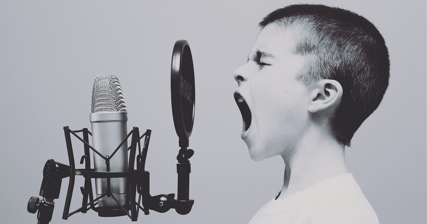 Child singing into a microphone
