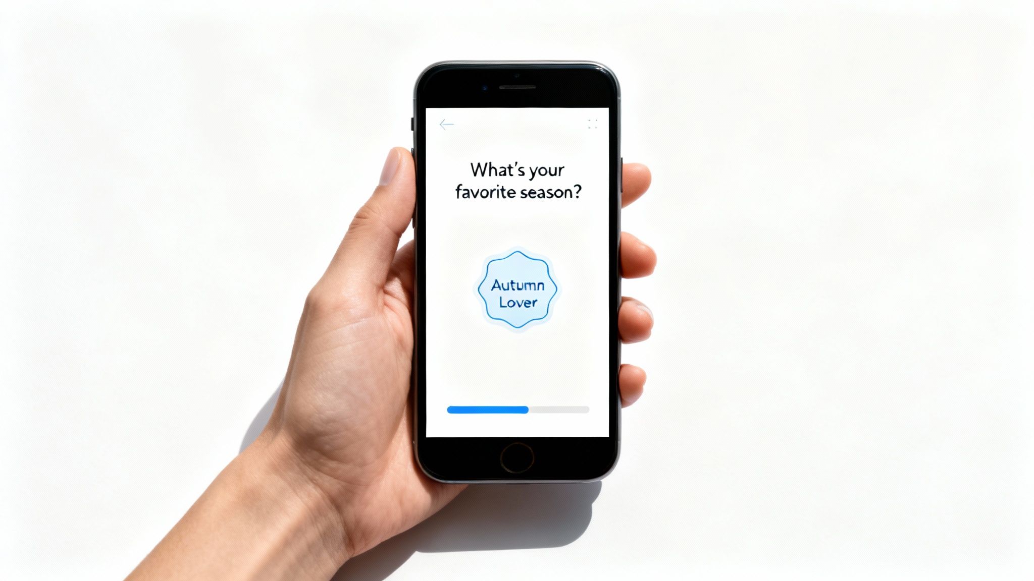 Hand holding smartphone displaying onboarding questionnaire asking about favorite season with autumn lover badge