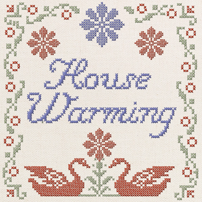 Cross-stitch pattern with the words 'House Warming' surrounded by floral borders and two swans.