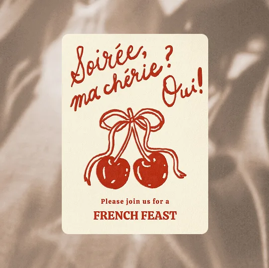 Invitation card with cherries tied by a ribbon and text inviting to a French feast.
