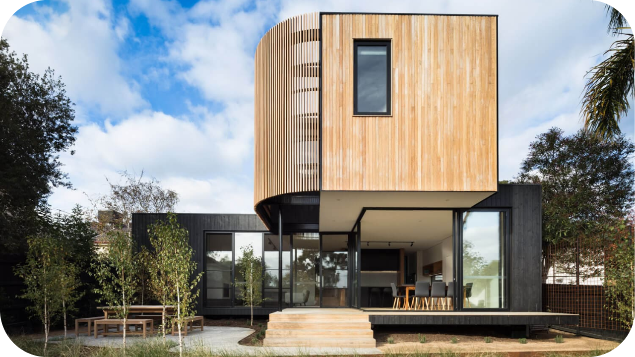 Contemporary Melbourne residence with vertical timber joinery, glass walls, and open outdoor area showcasing luxury residential joinery design.