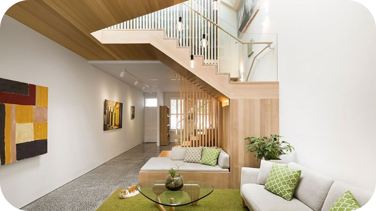 Contemporary open-plan home with timber staircase joinery and built-in seating under the stairs.