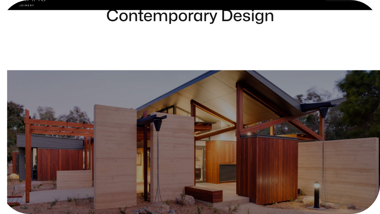 Contemporary home exterior with natural stone walls and timber joinery, designed for seamless balance of form and function.