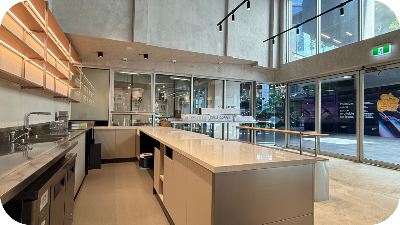 Contemporary industrial-style kitchen with sleek countertops, under-cabinet lighting, and an open layout, showcasing clean, functional joinery design.