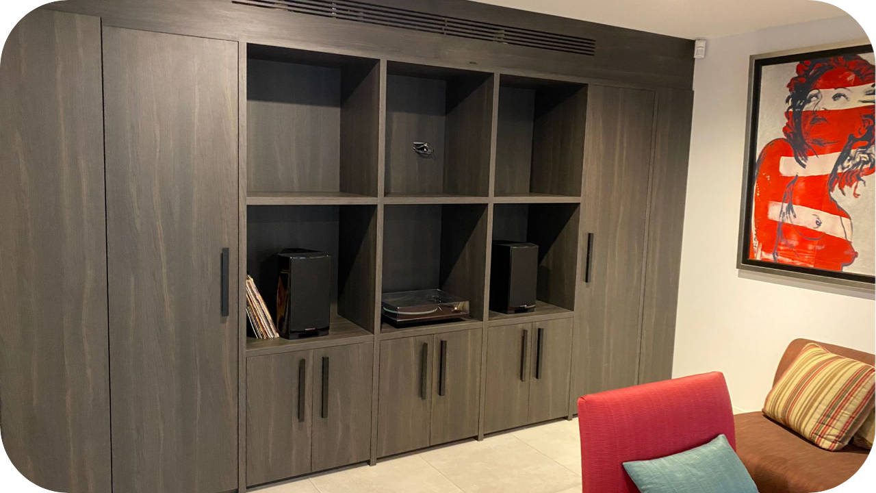 Custom-built entertainment unit with integrated shelving, storage cabinets, and modern timber joinery designed for a premium living space.
