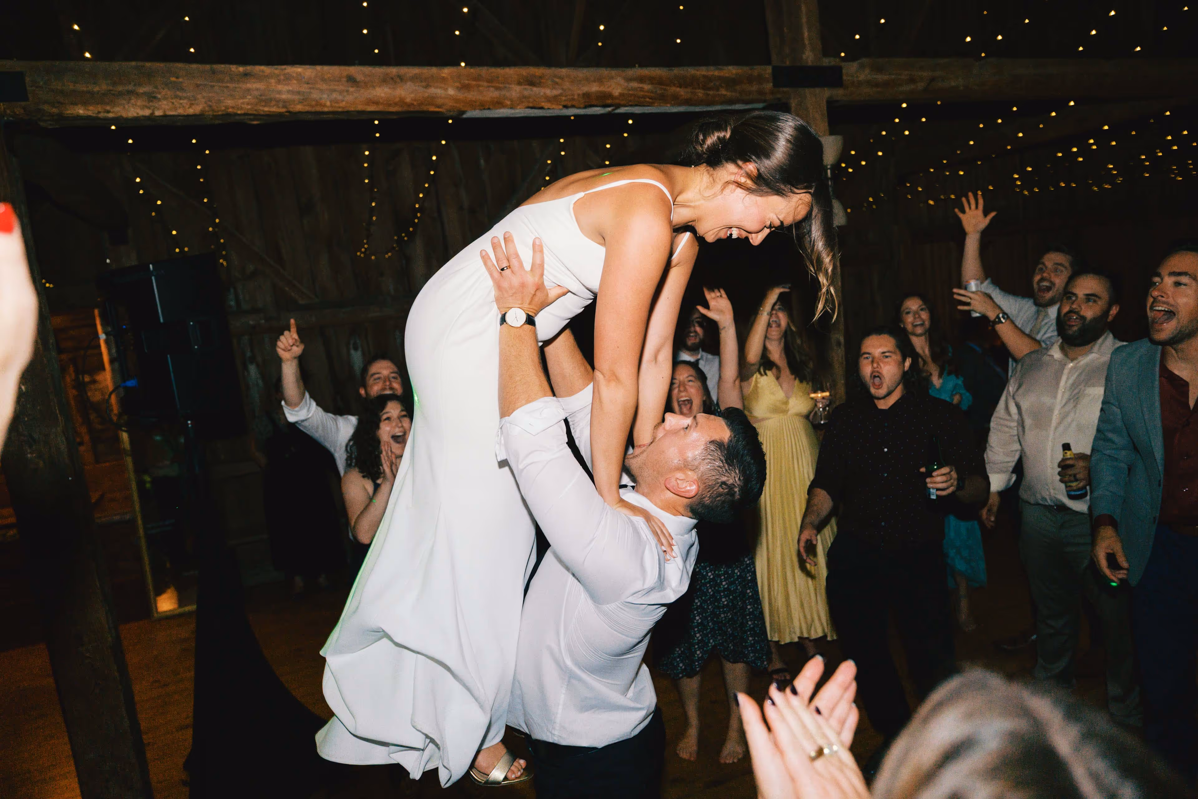 Candid photo of groom lifting bride like scene from Dirty Dancing, by CT documentary wedding photographer Tyler Jordan Soucy.