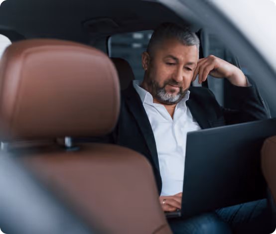 Main on laptop in backseat