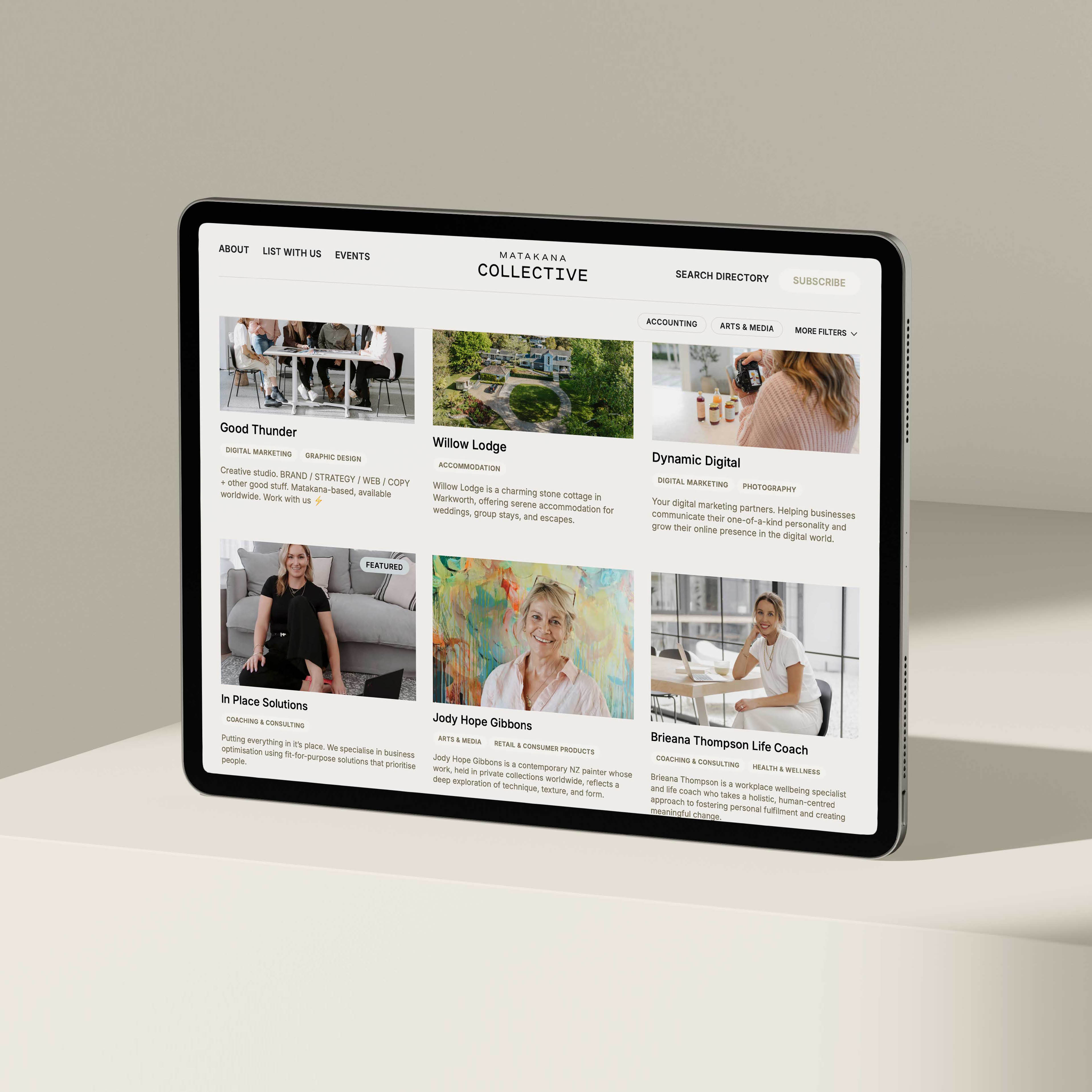 Tablet displaying a directory webpage titled Matakana Collective featuring listings for businesses like Good Thunder, Willow Lodge, Dynamic Digital, and others with images and descriptions.