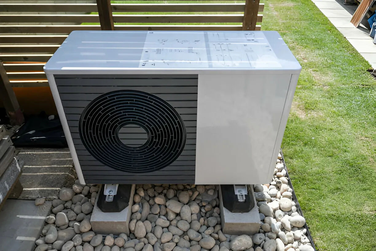 Outdoor heat pump on gravel.
