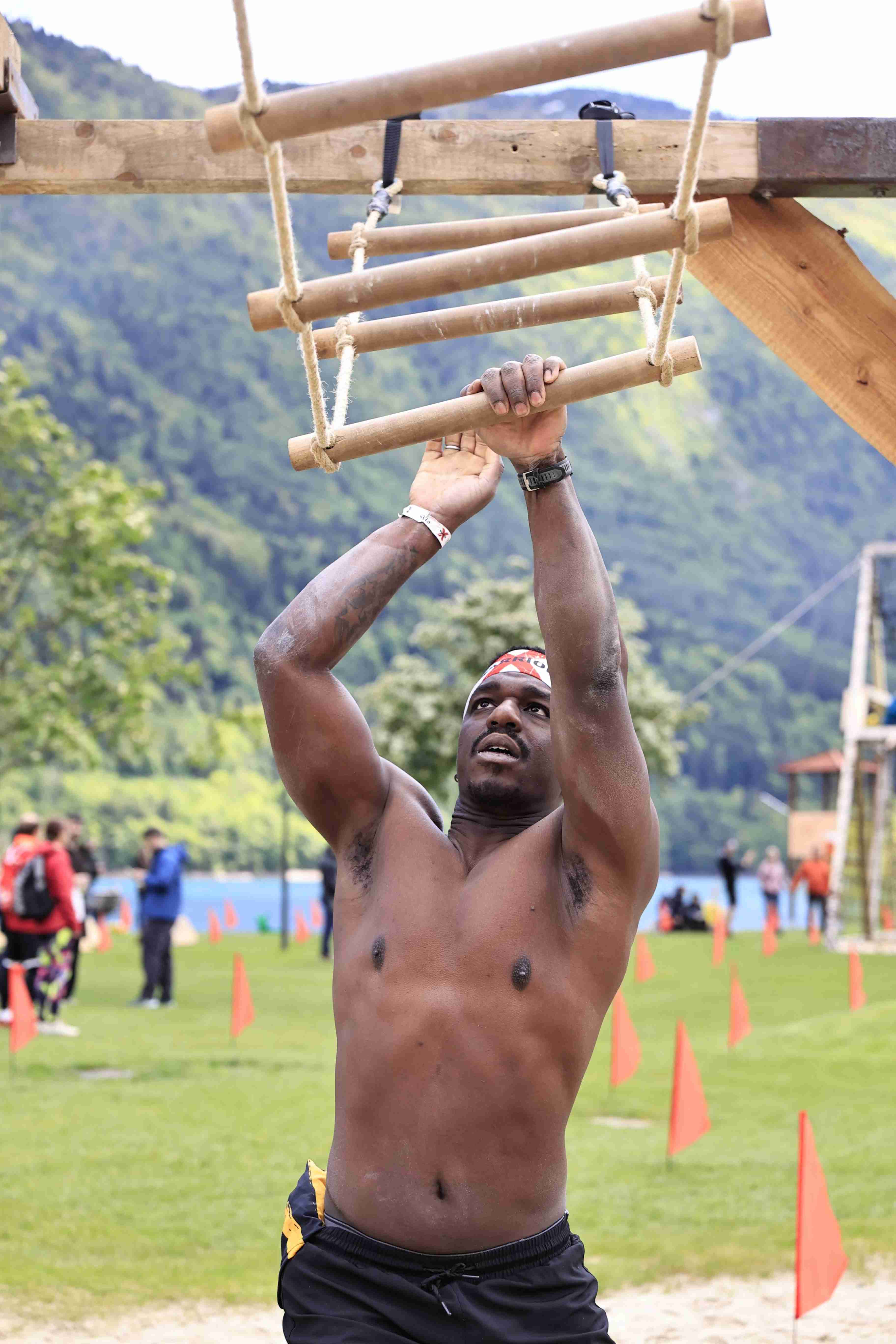 Athletes hanging on the rig and moving like monkeys over the sand in Molveno during the X Warriors race.