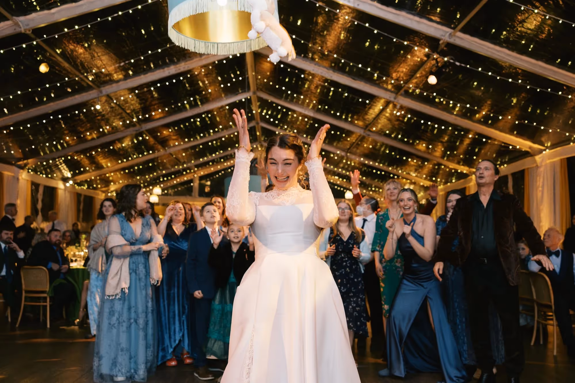 Bride tosses her stuffed animal puppy in the air instead of a traditional bouquet toss