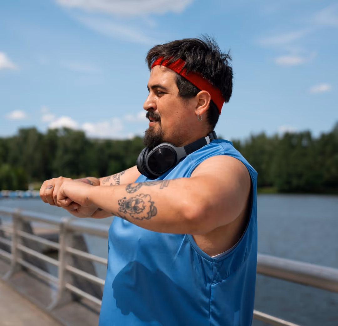 Man stretching by water Jem Social