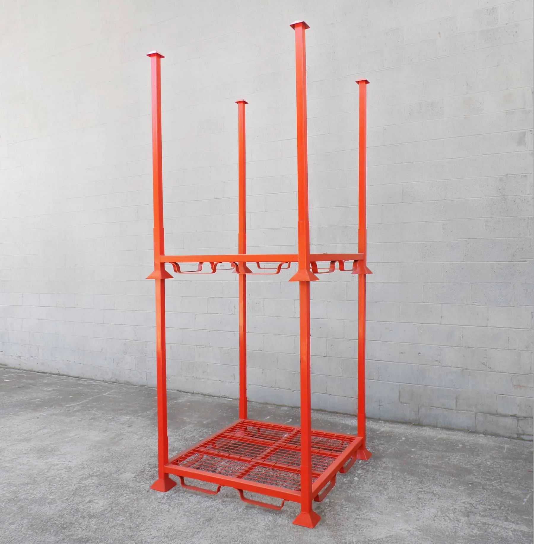 A photo of an orange steel stacking rack