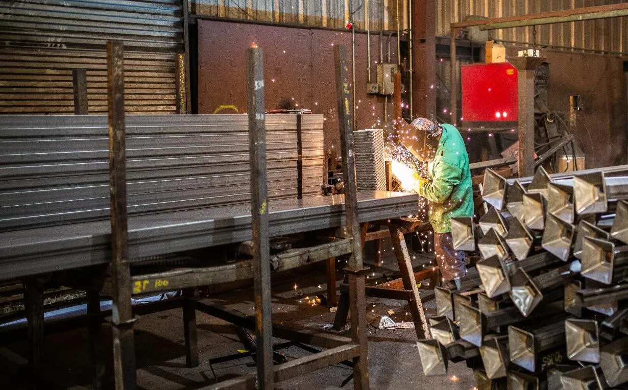 A welder welding steel racks