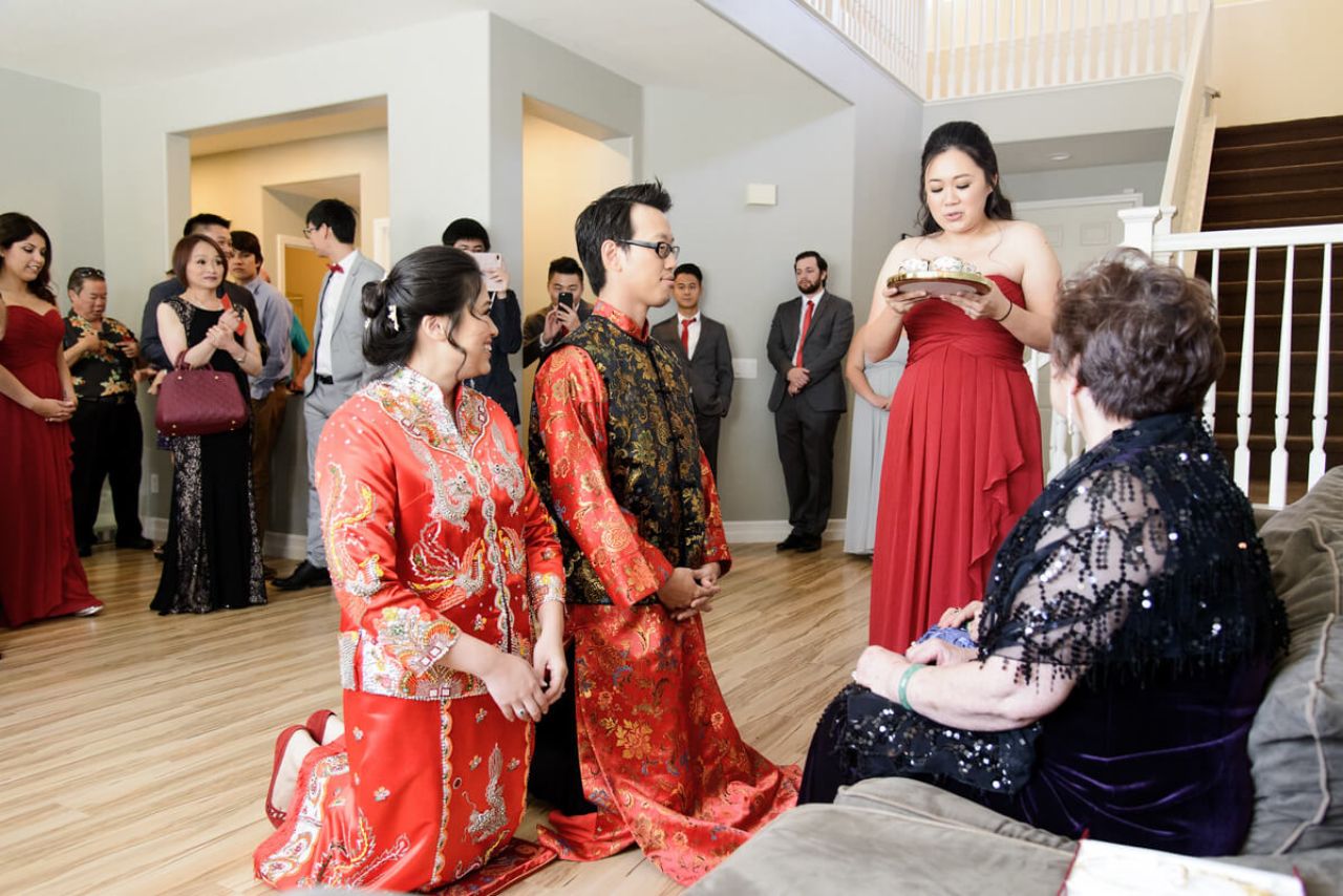 couple kneeling at a chinese wedding